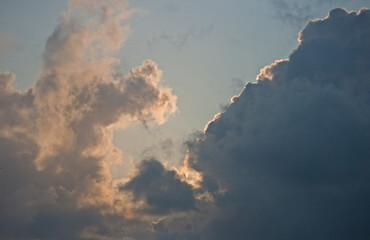 CLOUDS ILLUMINATED BY SUNSET LIGHT