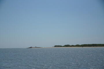 Calm waters serene island nature scene coastal region panoramic view tranquility and escape