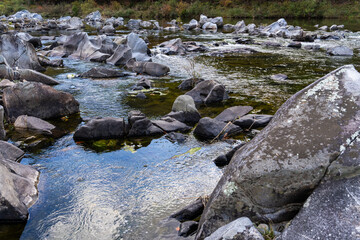 rocks and flowing stream in the autumn valley