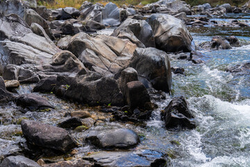 rocks and flowing stream in the autumn valley