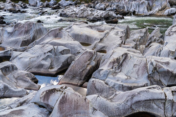 rocks and flowing stream in the autumn valley