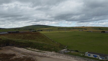 Scenic rural landscape with green hills and fields under a cloudy sky