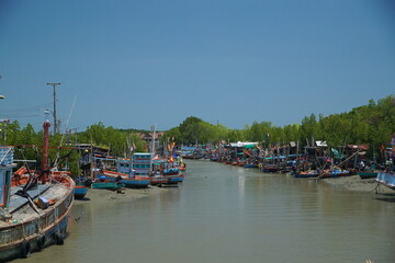 Fishing boats at a serene river coastal village landscape photography bright day wide angle tranquil nature scene