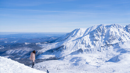 A woman climbing off, winter time, a lot of snow, view on Tatry mouintains © Arkadiusz