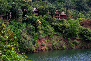 Fototapeta premium A view other cottages and river from a cottage of a resort