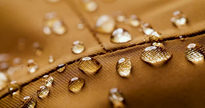 waterproof fabric - closeup of brown water resistant textile with water drops