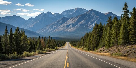 Fototapeta premium Empty stretch of asphalt road running parallel to a mountain range with a clear blue sky above and pine trees in the foreground, asphalt road, mountain view, peaceful scene, natural landscape, road 