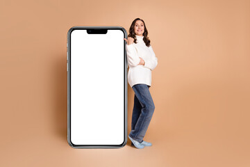 Photo of charming lovely woman wear trendy clothes presenting menu empty space isolated on beige...