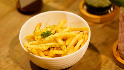 A French fries served in a bowl on a cafe table