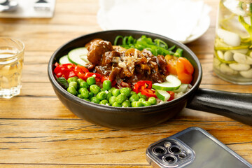 Beef Black Pepper Poke Bowl served on the table with Cappuccino and Iced Tea