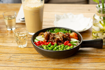 Beef Black Pepper Poke Bowl served on the table with Cappuccino and Iced Tea