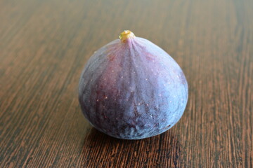 a fig on a dark table isolated close up