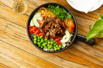 Beef Black Pepper Poke Bowl served on the table with Cappuccino and Iced Tea