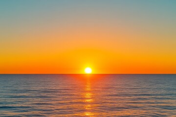 Fototapeta premium A breathtaking sunset over a tranquil ocean, with vibrant hues of orange and blue reflecting on the water