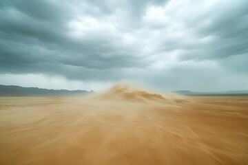 Fototapeta premium A dramatic landscape featuring swirling sand and dark, ominous clouds, capturing the essence of a fierce desert storm.