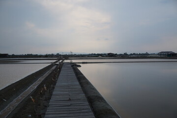 Tranquil sunset reflection over salt pans coastal region photography serene environment aerial view nature beauty