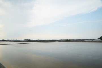 Calm water reflections coastal salt pans landscape photography tranquil environment wide view nature's serenity