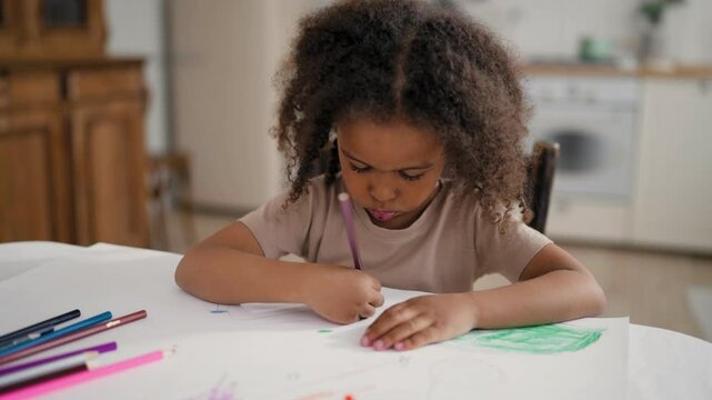 Smart and healthy little child drawing, portrait of black five-year-old girl. Carefree childhood, family concept, adopted baby, mixed race toddler playing alone at home, creativity and art for kids