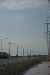 Roadside power lines and infrastructure development rural area photography open sky wide-angle view urban planning concepts