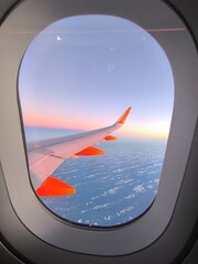View of the wing of a passenger plane from the porthole in the sky. Porthole sea plane.Photo taken of the wing of an airplane by a passenger,view from the porthole.View of the wing of the passenger. © AndreaMonica