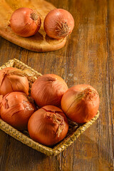 Fresh Brown Onions in a Woven Basket