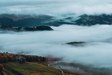 Morning mist over Seiser Alm in the Dolomites, Italy.