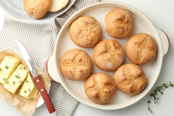 Flat lay composition with homemade tasty buns and butter on white table