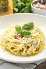 Delicious pasta Carbonara in bowl on table, closeup