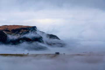 Morning mist over Seiser Alm in the Dolomites, Italy.