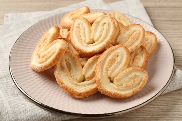 Delicious sweet palmier cookies on wooden table, closeup