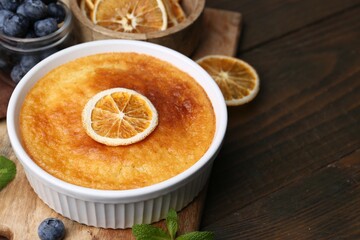 Tasty semolina cake served on wooden table, closeup. Space for text