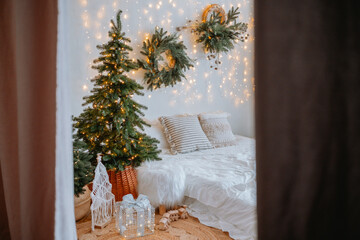 Cozy, festive bedroom adorned with holiday lights and greenery