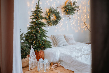 Cozy holiday bedroom with decorated trees and warm lighting in December
