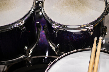 Drums and drum sticks in studio with no people.