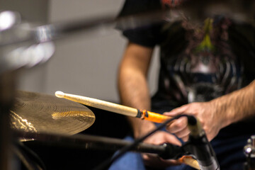 Close up of drummer playing drums on rehearsal in studio.