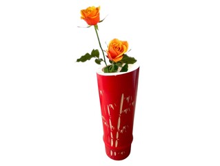 The picture shows a red vase with a pattern of bamboo and cream colored branches. The vase is made from bamboo that has been cut and decorated and painted red. It is used as a flower vase.
