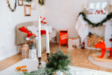 Cozy holiday living room decorated for Christmas with candles and greenery