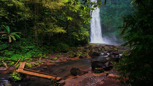 Bali waterfall Air Terjun Nungnung breathtaking 50-meter waterfall Bali's lush highlands. One of the most popular travel destinations Bali, Indonesia 4K