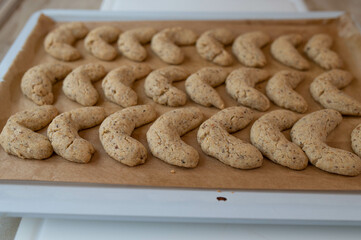 Homemade fresh baked and hot vanilla crescents on a baking tray