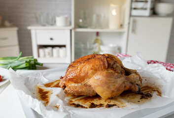Homemade fresh whole roasted chicken on kitchen counter