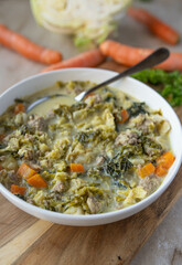 Savoy cabbage soup or stew with minced meat and vegetables fresh and homemade cooked on a plate with spoon