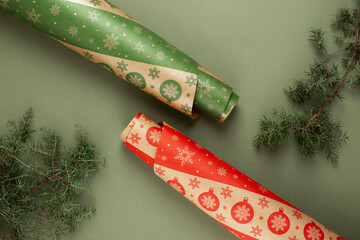 Christmas red and green wrapping paper rolls for gifts with drawing of the snowflakes on a green...