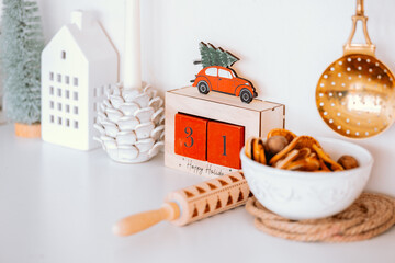 Decorative wooden calendar with a red car and festive elements on display