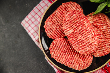 Raw cutlet fresh ground meat beef burger, pork, chicken, turkey second course dish fresh delicious gourmet food background on the table rustic food top view copy space