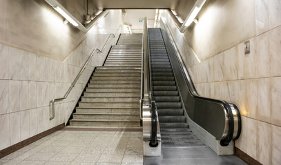 Underground empty electric escalators and stairway in the city center.