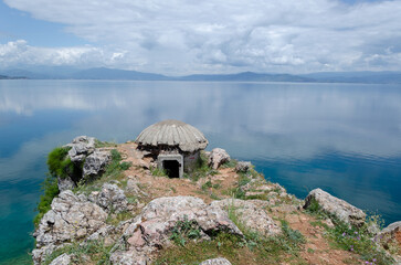 An abandoned concrete bunker sits perched on a rocky outcrop in the Lin village in Albania, overlooking the Ohrid Lake, a natural border between Albania and North Macedonia