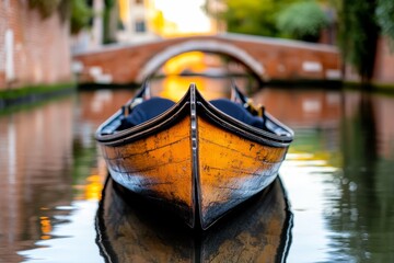 Obraz premium a gondola in Venice, Italy, floating on the water with a bridge in the background, surrounded by trees and buildings