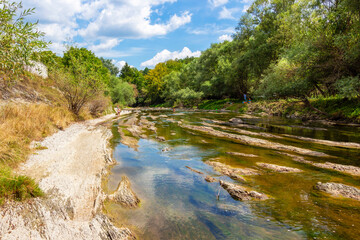 Sunny August view of the shallow waters of Vidima River in the Bulgarian Fore-Balkan village of Debnevo, Troyan Municipality