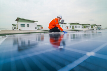 engineer man inspects construction of solar cell panel or photovoltaic cell by electronic device. Industrial Renewable energy of green power. factory worker working on tower roof.