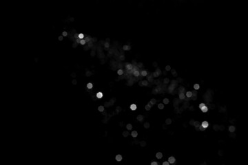 White gray blurred bokeh lights on black background. Glitter sparkle stars for celebrate. Overlay for your design